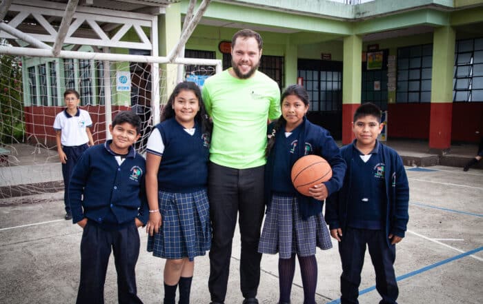Eric with students afte a basketball game