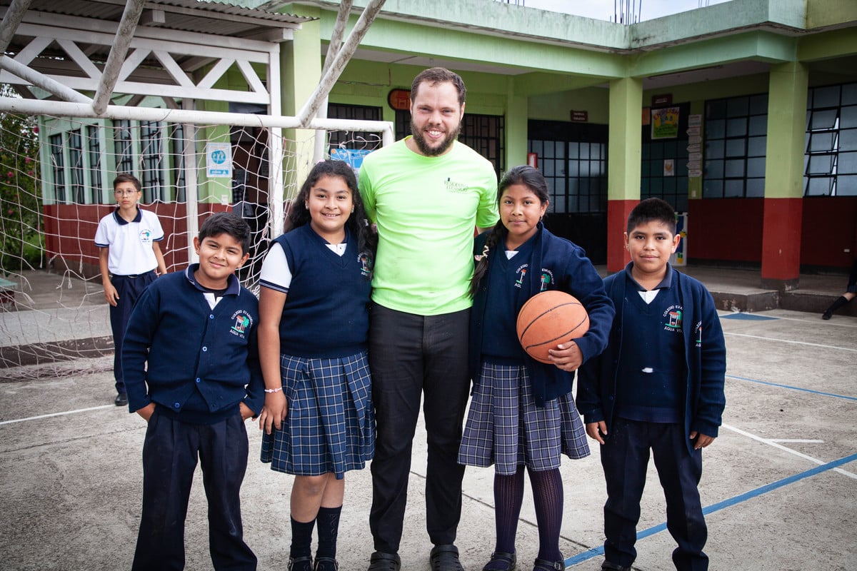 Eric with students afte a basketball game